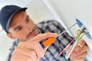 picture of a professional electrician while installing plug sockets
